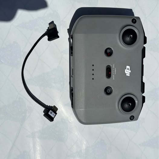 DJI drone controller with cable, dark grey back and buttons