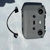DJI drone controller with cable, dark grey back and buttons