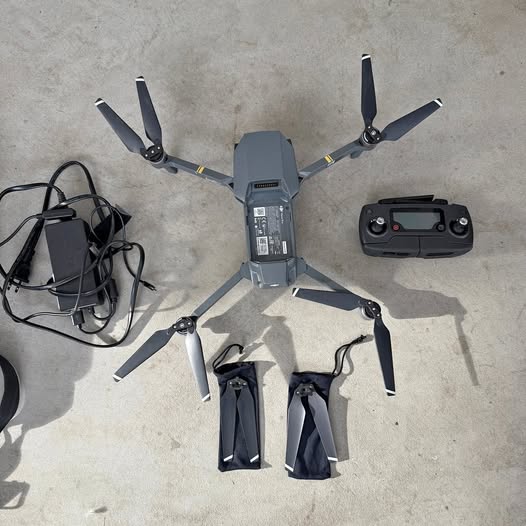 DJI Mavic Pro drone with controller and accessories, folded arms and propellers visible