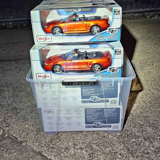 Orange convertible diecast model car in retail box, 1:18 scale, Maisto
