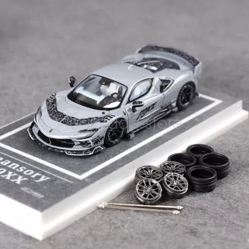 Grey 1/64 diecast model car with opened hood and matching accessory wheels