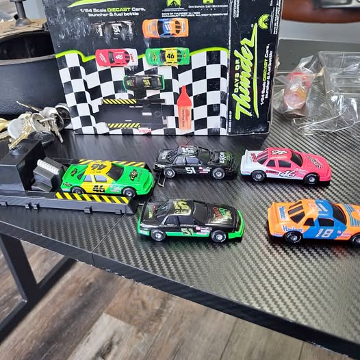 Diecast race cars set with four small cars on a display tray