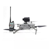 Drone megaphone speaker mount with black horn and remote controller, on gray drone body