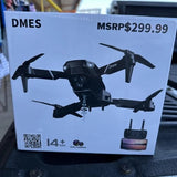 Foldable black quadcopter drone with four propellers, shown on retail box