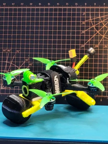 4-inch drone accessory kit parts: propellers and yellow arms on a compact frame