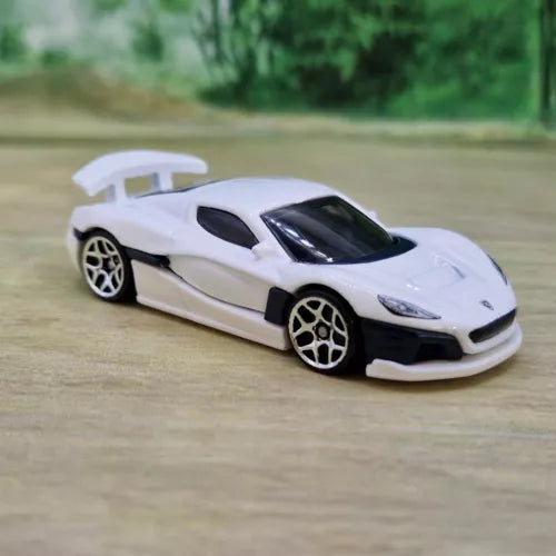 White sports diecast model car with black hood vents and dark tinted windows