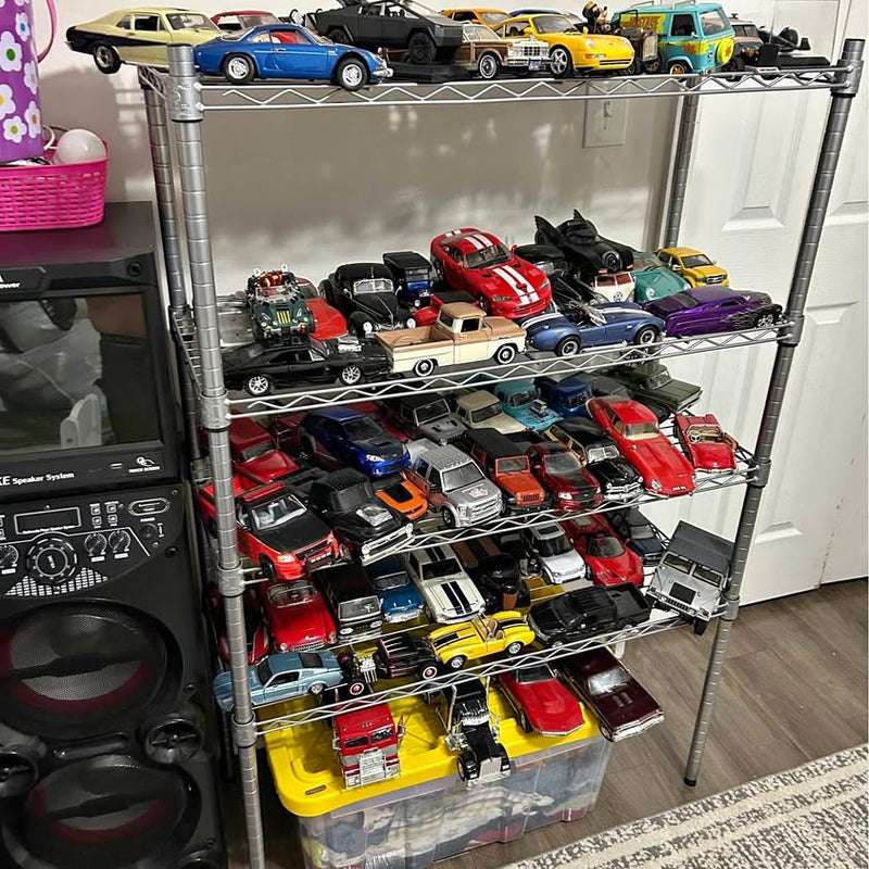Diecast toy cars on metal shelf, assorted colors and styles