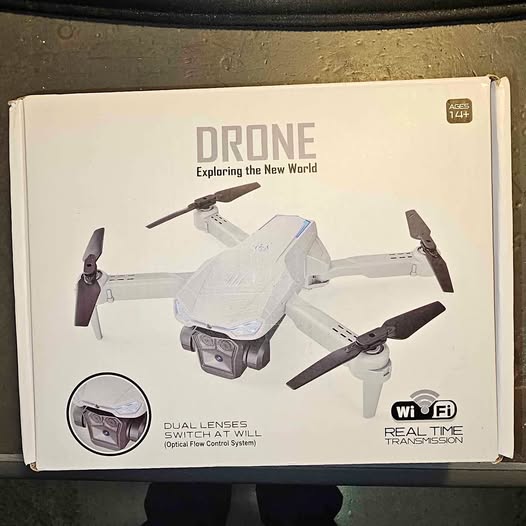 White quadcopter drone with mounted camera, shown on retail box packaging