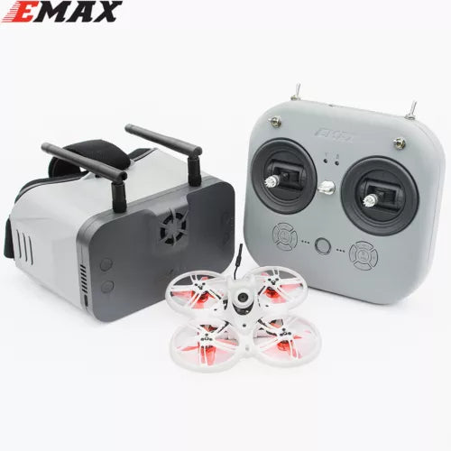 Racing drone kit with tiny quadcopter and gray radio transmitter with two antennas