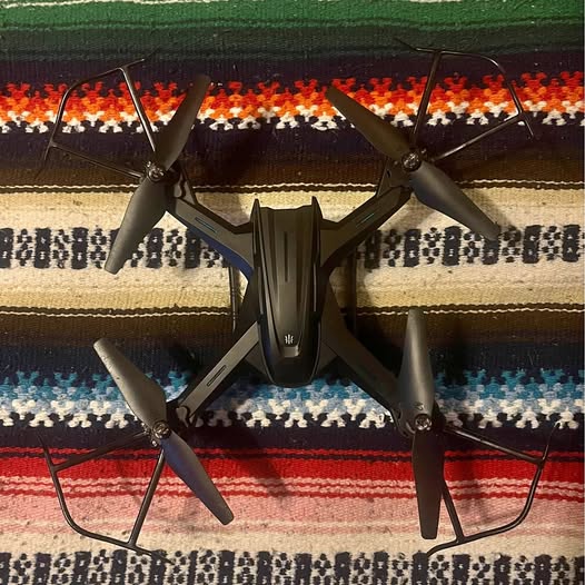 URANHUB four-axis drone with four propellers, dark body and legs, front view