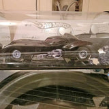 Diecast Batmobile toy car in clear blister package, dark gray with glossy details