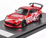 Red diecast sports racing car with Coca-Cola decals, black wheels, front 3/4 view