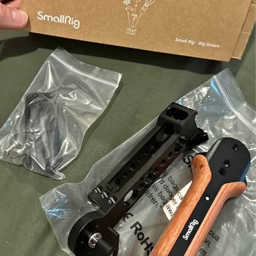SmallRig gimbal grip with black bracket and wooden handle, plus mounting screws