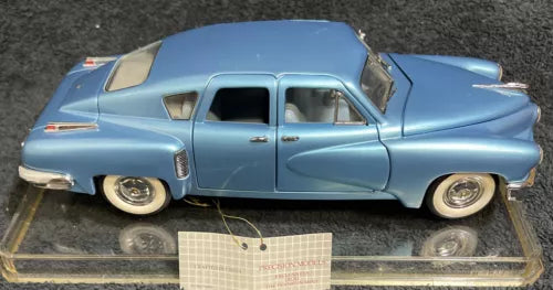 Light blue classic sedan diecast model car with display base, side view