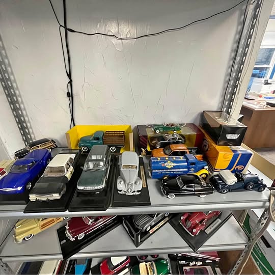 Assorted diecast trucks and cars in blue, yellow, green, orange, and black