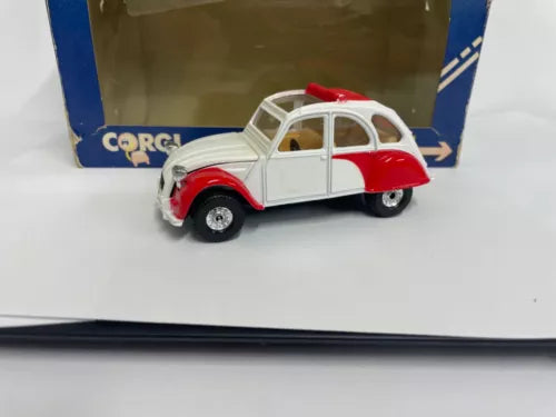 Diecast model car in red and white with open roll top roof, front 3/4 view.