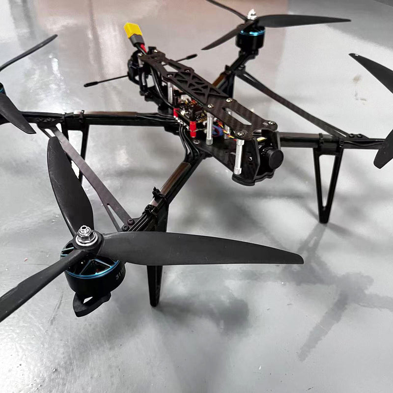 Black FPV racing quadcopter drone with four propellers and front camera mount