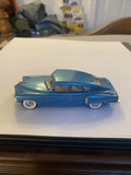 Blue vintage diecast sedan model car with chrome trim and whitewall wheels