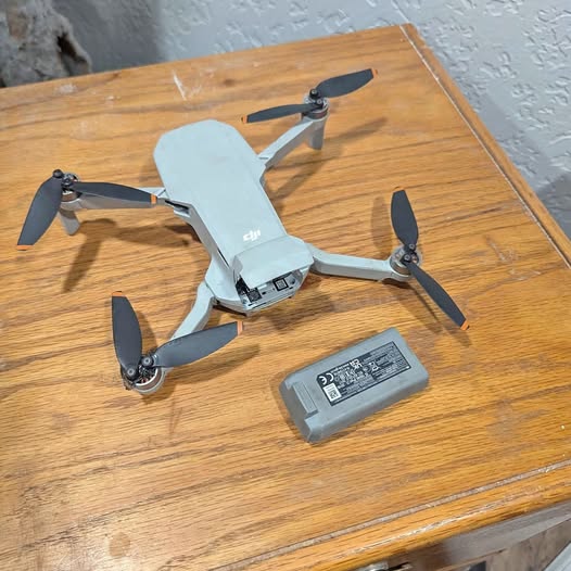 DJI Mini 2 drone with propellers and spare battery pack