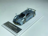 Blue metal diecast sports racing car with open wheels and rear spoiler