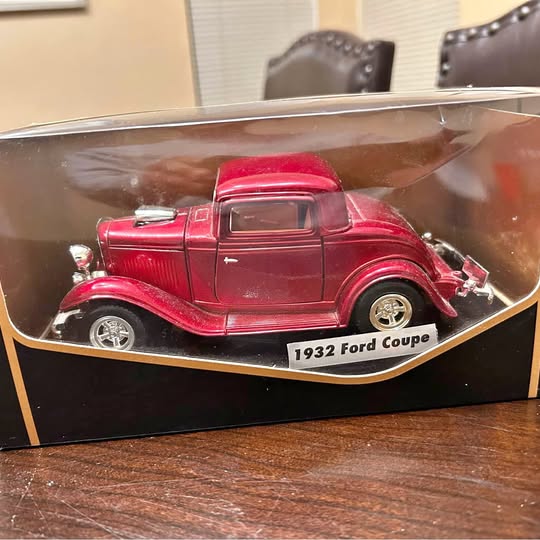 Red 1932 Ford Coupe diecast model car with clear display box and white base label