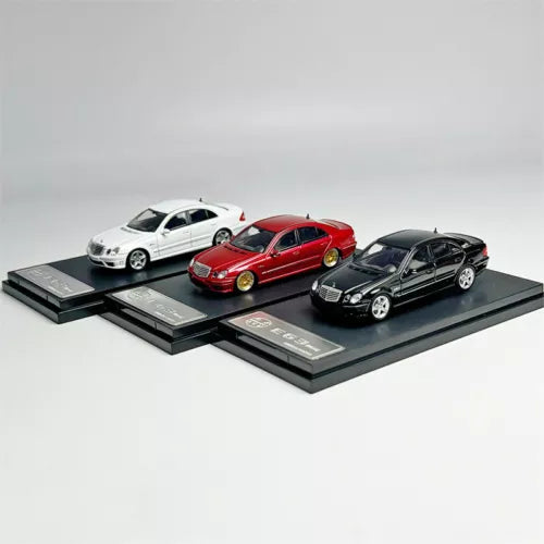 Diecast model car toy set with three sedans: white, red, black on display bases.