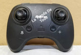 Black drone remote controller with two joysticks and front buttons, 'La Toda' logo