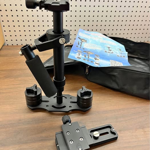 Black camera gimbal stabilizer rig with base plate and mounting arms