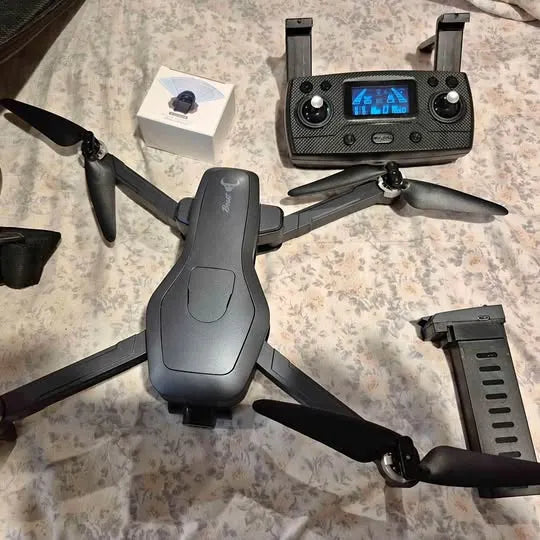 Gray quadcopter drone with handheld controller and LCD screen