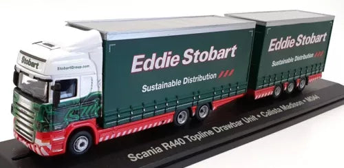 Model truck with white cab and green Eddie Stobart drawbar trailer on base