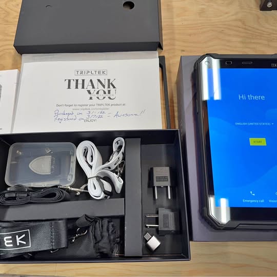 Drone accessory kit in open box: cables, charger, and adapter