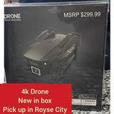 4K drone in retail box, gray quadcopter with camera bay pictured