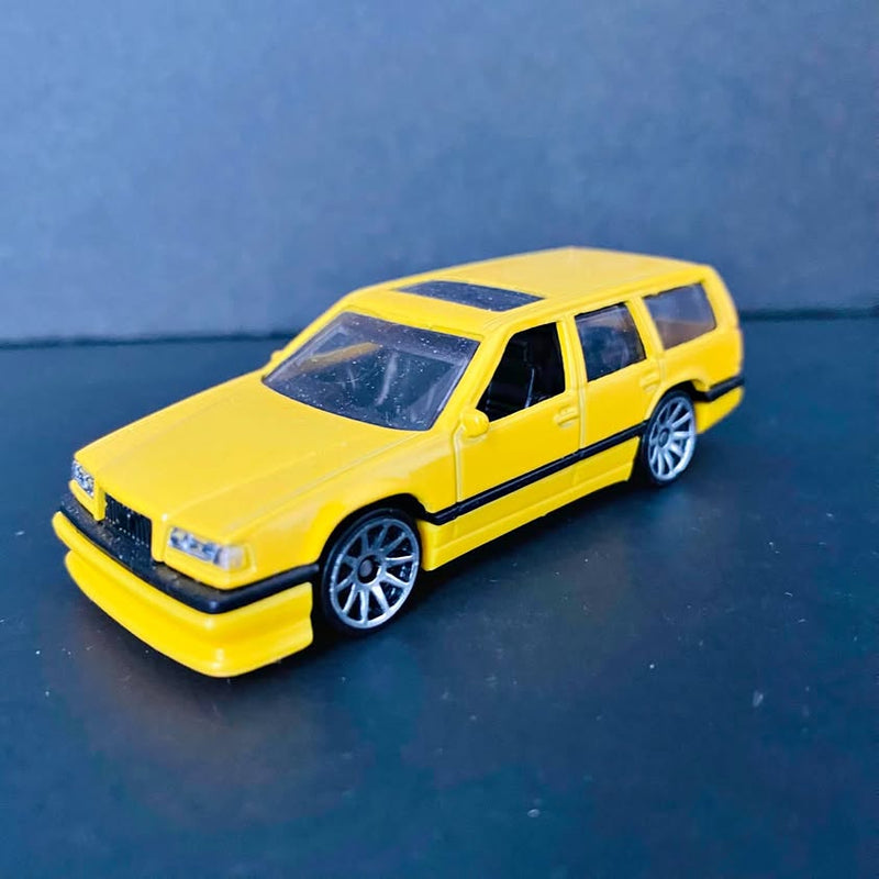 Yellow diecast station wagon model with black stripe and detailed wheels