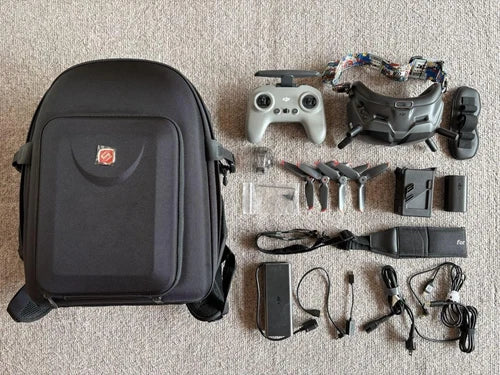 Drone accessory kit with black case, prop guards, landing gear, cables and tools
