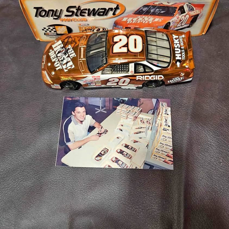 Tony Stewart diecast race car, orange #20 with black details and open hood graphics