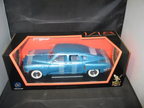 Blue 1/18 scale diecast car model in display box with clear window