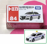 White diecast Toyota Crown taxi model car in retail box, blue stripe detail