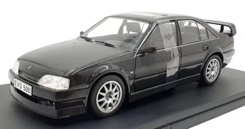 1/24 scale diecast sedan model in dark gray/black, front three-quarter view