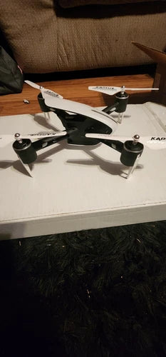White quadcopter drone with four propellers