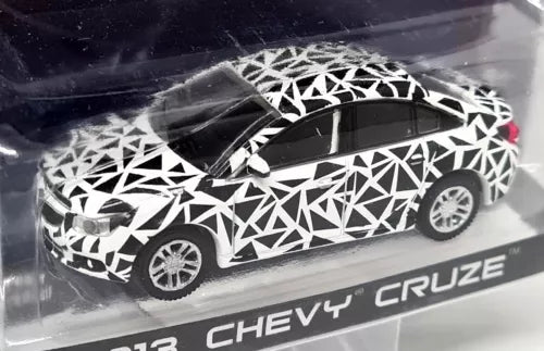 Diecast model car toy with black-and-white geometric wrap, front 3/4 view.