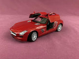 Red diecast sports car model with open gullwing doors, 1/24 scale