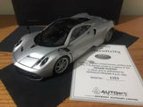 Silver 1:18 diecast sports car with black hood vents, front three-quarter view