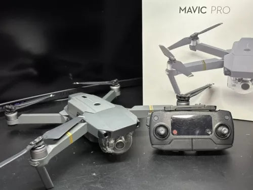 Gray quadcopter drone with remote controller and attached camera gimbal