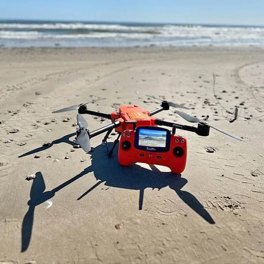 Orange SWELLPRO fishing drone with camera screen and four black propellers