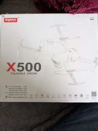Syma X500 foldable drone retail box with X500 text and line-drawn quadcopter