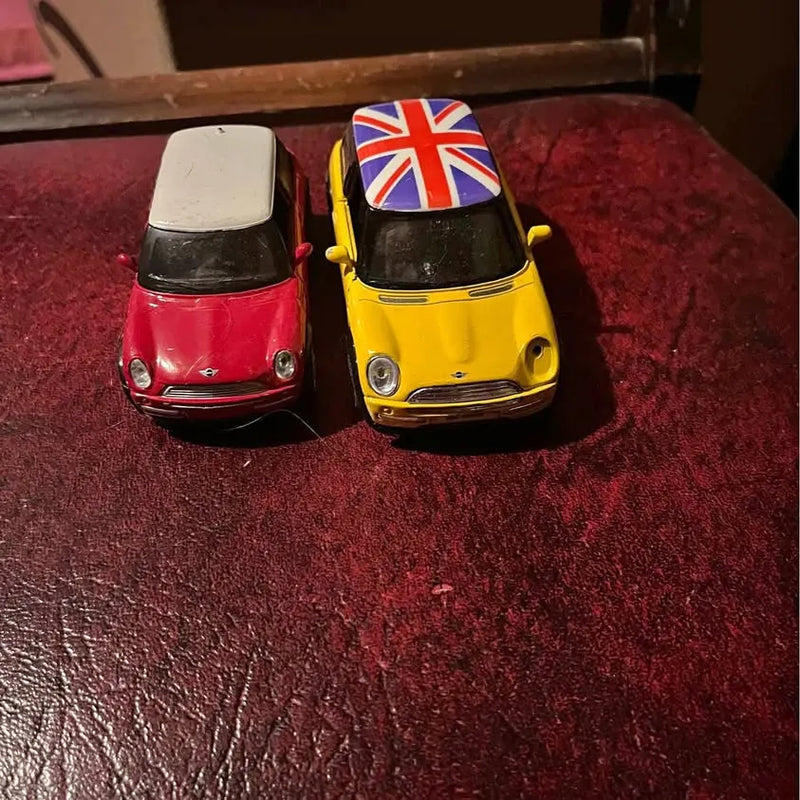 Mini diecast cars, red and yellow with Union Jack roof