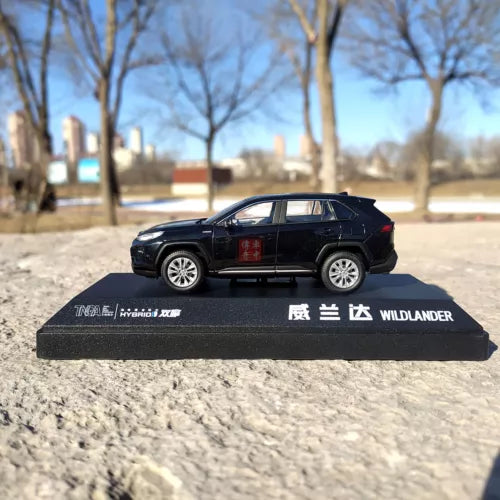 Black-blue diecast SUV model on display base, side view, WILDLANDER text on base