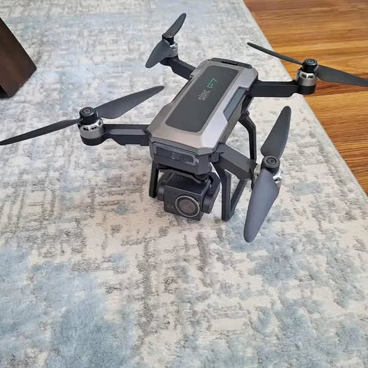Gray quadcopter drone with 4 propellers and front camera gimbal