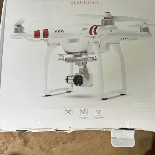 White DJI Phantom 3 quadcopter drone with red arms and front camera gimbal