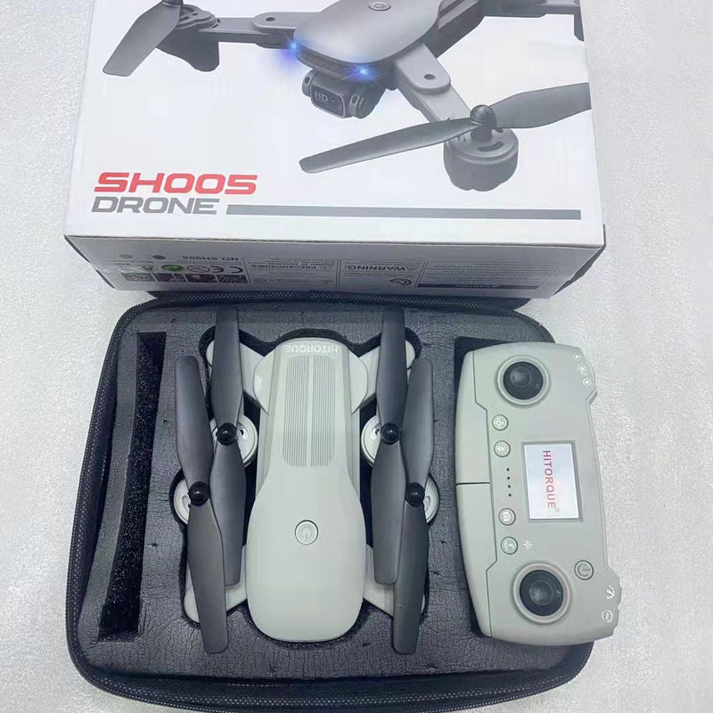 Electric mini drone with 4 propellers and handheld remote inside open case